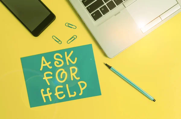 Conceptual hand writing showing Ask For Help. Business photo showcasing Request to support assistance needed Professional advice Trendy open laptop smartphone marker paper sheet clips.