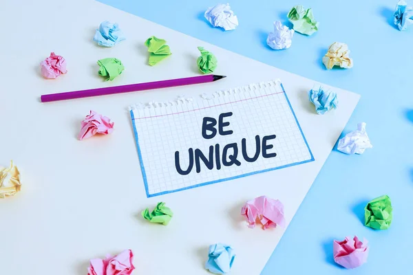 Word writing text Be Unique. Business concept for being the only one of its kind Unlike anything else Incomparable Colored crumpled papers empty reminder blue yellow background clothespin. — Stock Photo, Image