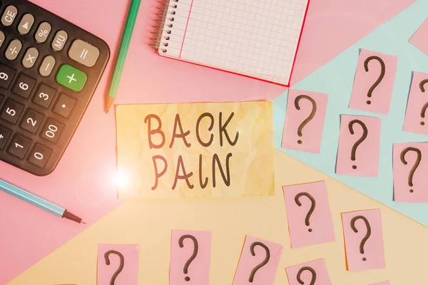 Writing note showing Back Pain. Business photo showcasing Soreness of the bones felt at the lower back portion of the body Mathematics stuff and writing equipment above pastel colours background.