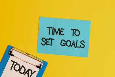 Text sign showing Time To Set Goals. Conceptual photo Desired Objective Wanted to accomplish in the future Metal clipboard holding blank paper sheet square page colored background.