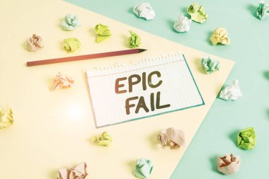 Word writing text Epic Fail. Business concept for a spectacularly embarrassing mistake Humiliating situation Colored crumpled papers empty reminder blue yellow background clothespin.
