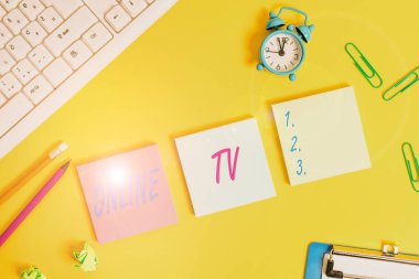 Writing note showing Online Tv. Business photo showcasing a television production broadcast in realtime as events happen Flat lay above copy space on the white crumpled paper.