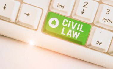 Conceptual hand writing showing Civil Law. Business photo text Law concerned with private relations between members of community White pc keyboard with note paper above the white background.
