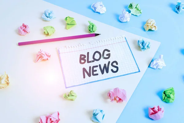 Word writing text Blog News. Business concept for regularly updated website typically one run by an individual Colored crumpled papers empty reminder blue yellow background clothespin.