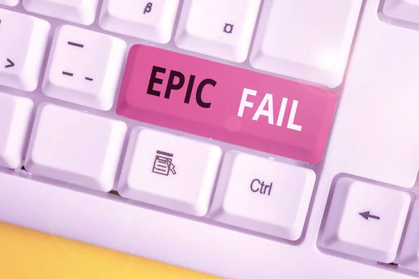 Conceptual hand writing showing Epic Fail. Business photo text a spectacularly embarrassing mistake Humiliating situation White pc keyboard with note paper above the white background. — Stock Photo, Image