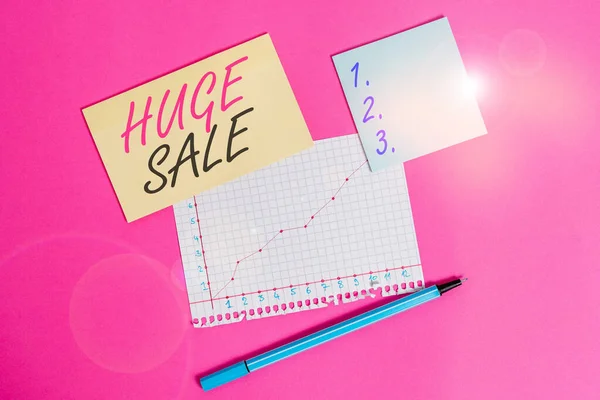 Writing note showing Huge Sale. Business photo showcasing putting products on high discount Great price Black Friday Stationary and note paper math sheet with diagram picture on the table.