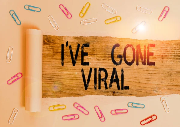 Conceptual hand writing showing I Ve Gone Viral. Business photo showcasing medical term used to describe small infectious agent Paper clip and torn cardboard on wood classic table backdrop.