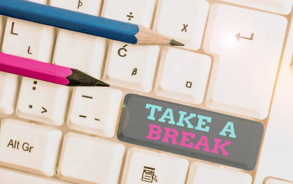 Conceptual hand writing showing Take A Break. Business photo showcasing Resting Stop doing something recreation time get out of work White pc keyboard with note paper above the white background. — Stock Photo, Image