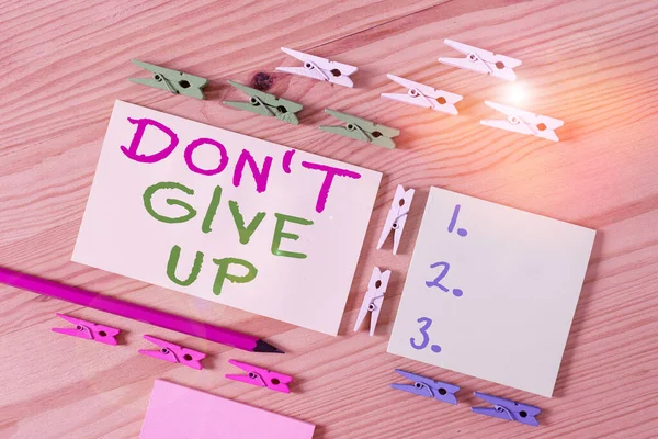 Text sign showing Don T Give Up. Conceptual photo Determined Persevering Continue to Believe in Yourself Colored clothespin papers empty reminder wooden floor background office. — 图库照片