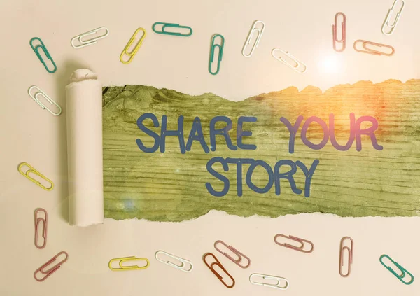 Handwriting text Share Your Story. Concept meaning asking someone to about himself write life Biography Paper clip and torn cardboard placed above a wooden classic table backdrop.