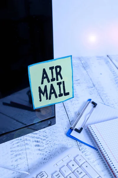 Text sign showing Air Mail. Conceptual photo the bags of letters and packages that are transported by aircraft Note paper taped to black computer screen near keyboard and stationary. — Stock Photo, Image