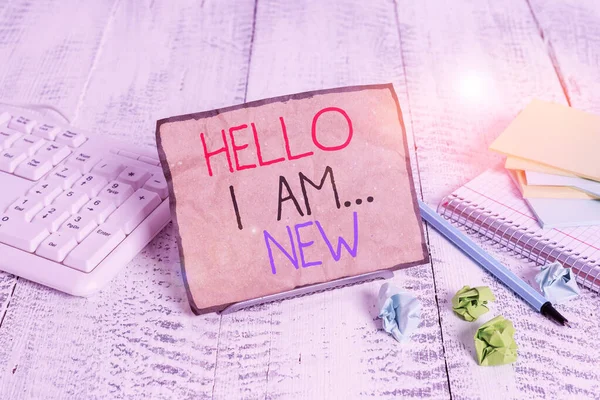 Conceptual hand writing showing Hello I Am New. Business photo showcasing Introduce yourself Meeting Greeting Work Fresh worker School Notepaper on wire in between computer keyboard and sheets. — Stock Photo, Image