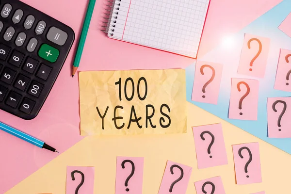 Writing note showing 100 Years. Business photo showcasing Remembering special day for being 100 years in existence Mathematics stuff and writing equipment above pastel colours background.