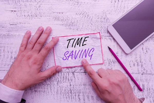 Writing note showing Time Saving. Business photo showcasing the act of reducing the amount of time needed to do something Hand hold note paper near writing equipment and smartphone. — Stock Photo, Image