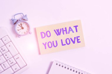Conceptual hand writing showing Do What You Love. Business photo text Make enjoyable things do activities with motivation Keyboard with empty note paper and pencil white background.