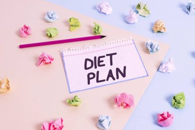 Word writing text Diet Plan. Business concept for detailed proposal for doing or achieving a heathy eating habit Colored crumpled papers empty reminder blue yellow background clothespin.