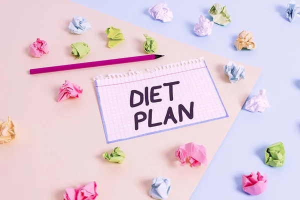 Word writing text Diet Plan. Business concept for detailed proposal for doing or achieving a heathy eating habit Colored crumpled papers empty reminder blue yellow background clothespin. — ストック写真