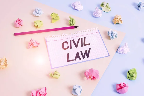 Word writing text Civil Law. Business concept for Law concerned with private relations between members of community Colored crumpled papers empty reminder blue yellow background clothespin.