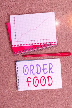 Word writing text Order Food. Business concept for the process of requesting a preferred food in a restaurant Desk notebook paper office cardboard paperboard study supplies table chart.
