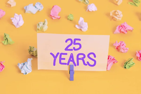 Handwriting text writing 25 Years. Concept meaning Remembering or honoring special day for being 25 years in existence Colored crumpled papers empty reminder white floor background clothespin. — Stock Photo, Image