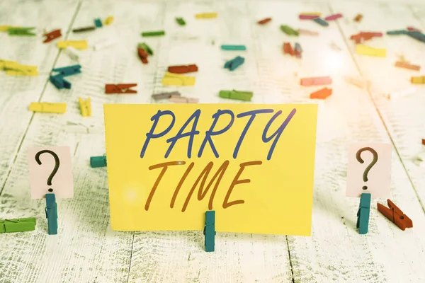 Writing note showing Party Time. Business photo showcasing the right moment to celebrate and have fun in social event Crumbling sheet with paper clips placed on the wooden table.