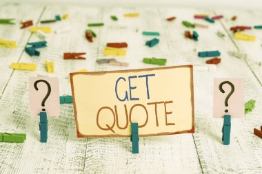 Word writing text Get Quote. Business concept for the most recent price to which a buyer and seller agreed Scribbled and crumbling sheet with paper clips placed on the wooden table.