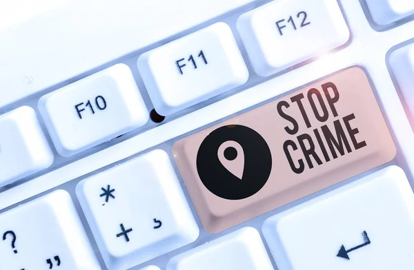 Conceptual hand writing showing Stop Crime. Business photo showcasing the effort or attempt to reduce and deter crime and criminals White pc keyboard with note paper above the white background. — Stock Photo, Image