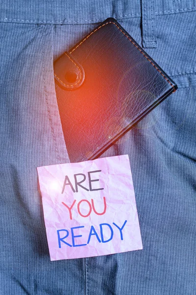 Text sign showing Are You Ready. Conceptual photo Alertness Preparedness Urgency Game Start Hurry Wide awake Small little wallet inside man trousers front pocket near notation paper. — Stockfoto