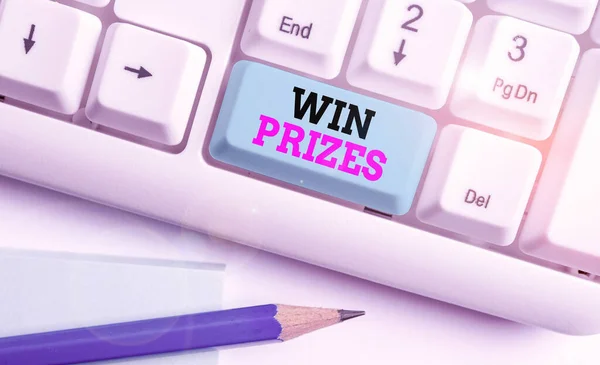 Word writing text Win Prizes. Business concept for something given for victory in a contest or competition White pc keyboard with empty note paper above white background key copy space.