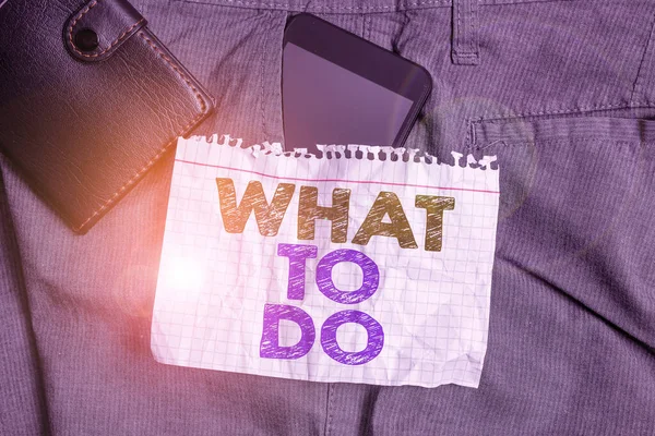 Word writing text What To Do. Business concept for asking someone advice about next action is going to be made Smartphone device inside trousers front pocket with wallet and note paper. — Stock Photo, Image