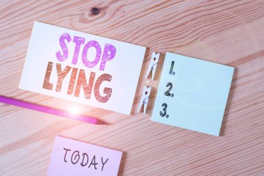 Conceptual hand writing showing Stop Lying. Business photo text put an end on chronic behavior of compulsive or habitual lying Colored crumpled papers wooden floor background clothespin. clipart