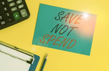 Writing note showing Save Not Spend. Business photo showcasing Keeping money for investment instead of buying not needed Clipboard blank sheet square page calculator pencil colored background.