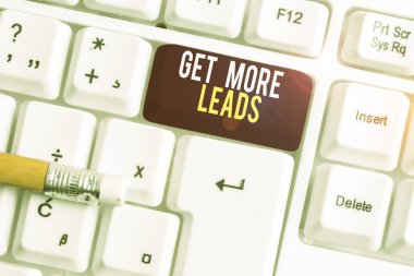 Text sign showing Get More Leads. Conceptual photo Look for new clients customers followers Marketing strategy White pc keyboard with empty note paper above white background key copy space.
