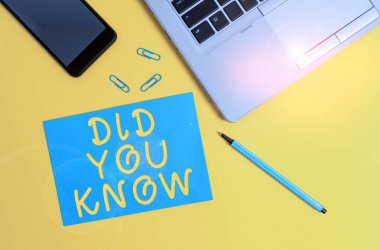 Conceptual hand writing showing Did You Know. Business photo showcasing Knowing the next move Thinking Trivia Brainstorming Wondering Trendy open laptop smartphone marker paper sheet clips.