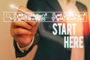 Text sign showing Start Here. Conceptual photo telling someone this is beginning point to go from to destination.