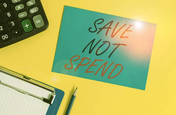 Writing note showing Save Not Spend. Business photo showcasing Keeping money for investment instead of buying not needed Clipboard blank sheet square page calculator pencil colored background. — Stok fotoğraf