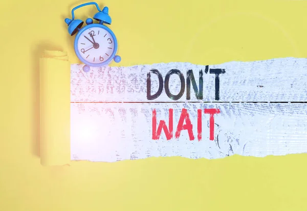 Conceptual hand writing showing Don T Wait. Business photo text Take action now and do something for a purpose Act quickly Alarm clock and torn cardboard on a wooden classic table backdrop. — Stock Photo, Image