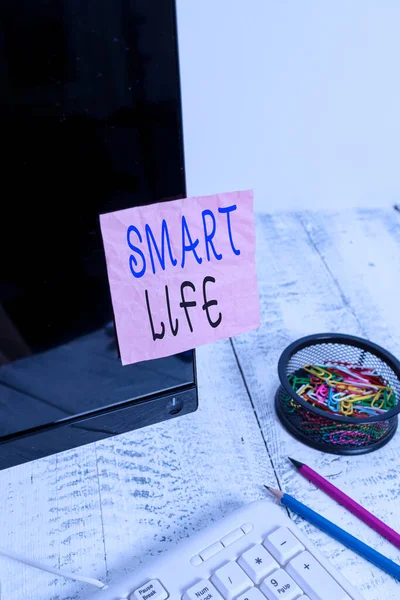 Handwriting text writing Smart Life. Concept meaning approach conceptualized from a frame of prevention and lifestyles Note paper taped to black computer screen near keyboard and stationary.