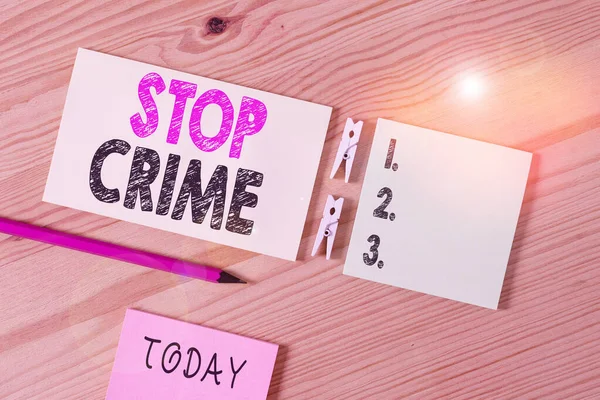 Conceptual hand writing showing Stop Crime. Business photo text the effort or attempt to reduce and deter crime and criminals Colored crumpled papers wooden floor background clothespin. — Stock Photo, Image