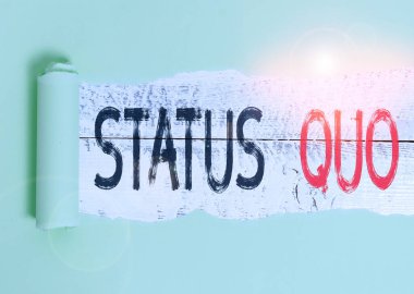 Conceptual hand writing showing Status Quo. Business photo showcasing existing state of affairs regarding social or political issues Cardboard which is torn placed above a wooden classic table.