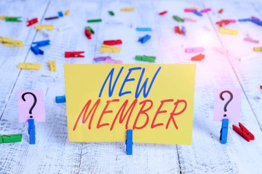 Writing note showing New Member. Business photo showcasing recruiting employee to company or team Birth of fresh child Crumbling sheet with paper clips placed on the wooden table.