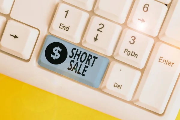 Writing note showing Short Sale. Business photo showcasing Home that is offered at a price that is less than the amount owed White pc keyboard with note paper above the white background.