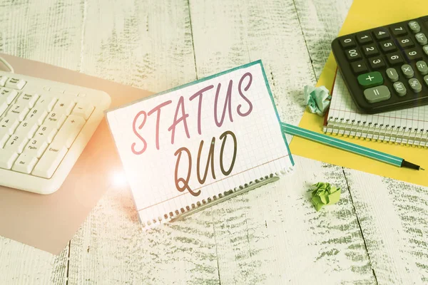 stock image Text sign showing Status Quo. Conceptual photo existing state of affairs regarding social or political issues Notepaper stand on buffer wire in between computer keyboard and math sheets.
