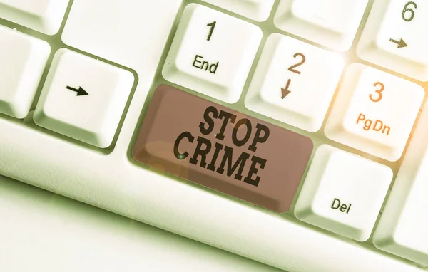 Word writing text Stop Crime. Business concept for the effort or attempt to reduce and deter crime and criminals White pc keyboard with empty note paper above white background key copy space. — Stockfoto