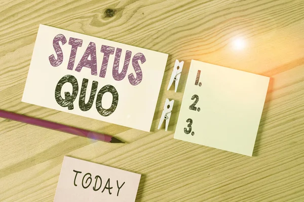 Conceptual hand writing showing Status Quo. Business photo text existing state of affairs regarding social or political issues Colored crumpled papers wooden floor background clothespin. — Stok fotoğraf