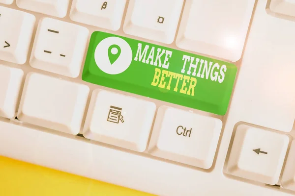 Escribiendo una nota que muestra Make Things Better. Exhibición de fotos de negocios Haga algo para mejorarse Sea el teclado blanco de la PC de la ley del cambio con el papel de nota sobre el fondo blanco . — Foto de Stock