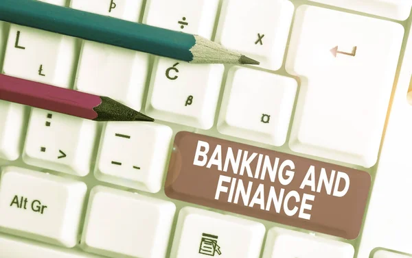 Text sign showing Banking And Finance. Conceptual photo Accounting and entities stocks Money interests White pc keyboard with empty note paper above white background key copy space. — Stock Photo, Image