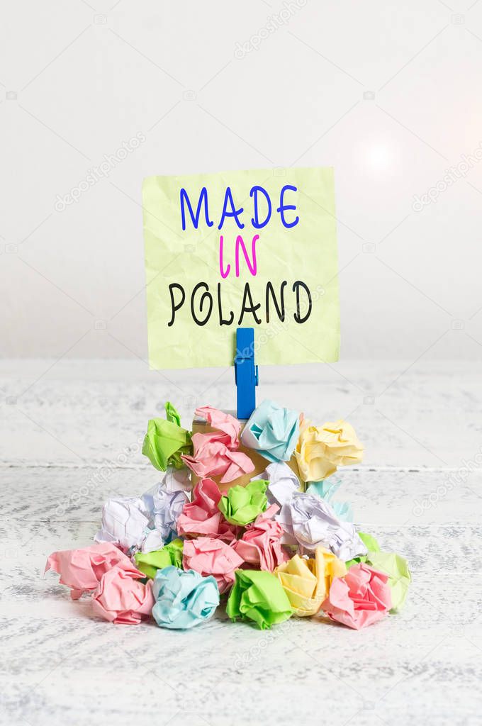 Writing note showing Made In Poland. Business photo showcasing A product or something that is analysisufactured in Poland Reminder pile colored crumpled paper clothespin wooden space.