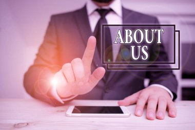 Writing note showing About Us. Business photo showcasing to introduce who or what something relates to or concerns Male human wear formal clothes present use hitech smartphone.