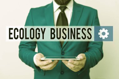 Text sign showing Ecology Business. Conceptual photo global ecology and environment protection business Businessman in blue suite with a tie holds lap top in hands.